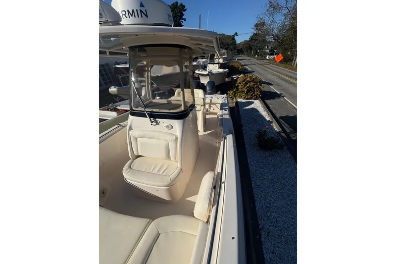 Slide: The Image of 2017 Grady-White Fisherman 257 boat with seating, parked near a road. - 10