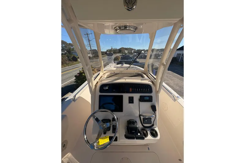 Slide: The Image of 2017 Grady-White Fisherman 257 boat dashboard with steering wheel and controls. - 13