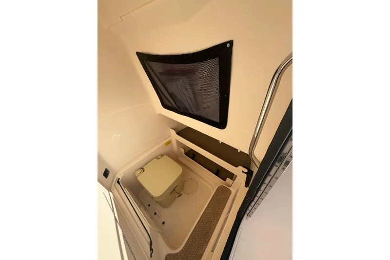 Slide: The Image of 2017 Grady-White Fisherman 257 boat interior with compact toilet and storage area. - 15