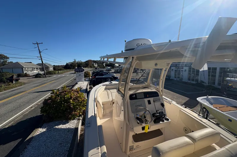 Slide: The Image of 2017 Grady-White Fisherman 257 boat on display at a marina under clear blue skies. - 18