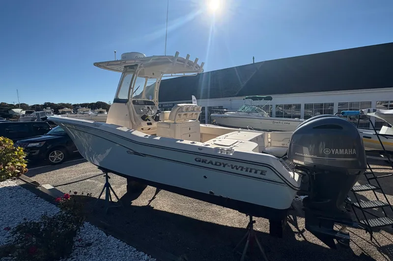 Slide: The Image of 2017 Grady-White Fisherman 257 boat with Yamaha engine in a sunny marina setting. - 2