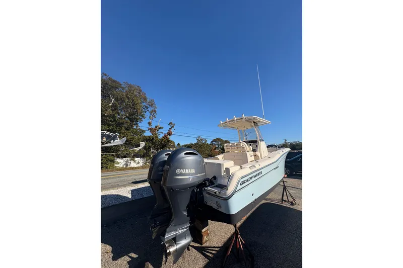 Slide: The Image of 2017 Grady-White Fisherman 257 boat with Yamaha engines, displayed outdoors under clear blue sky. - 5