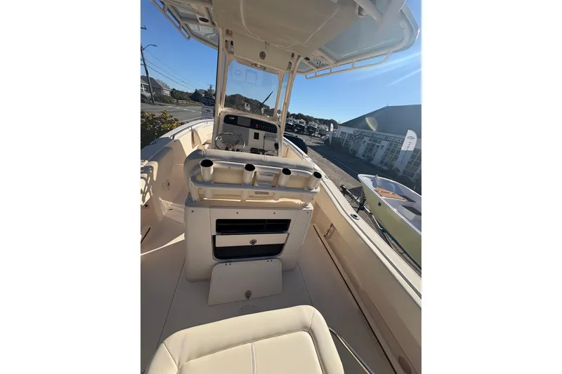 Slide: The Image of 2017 Grady-White Fisherman 257 boat interior with console and seating, docked outdoors. - 6
