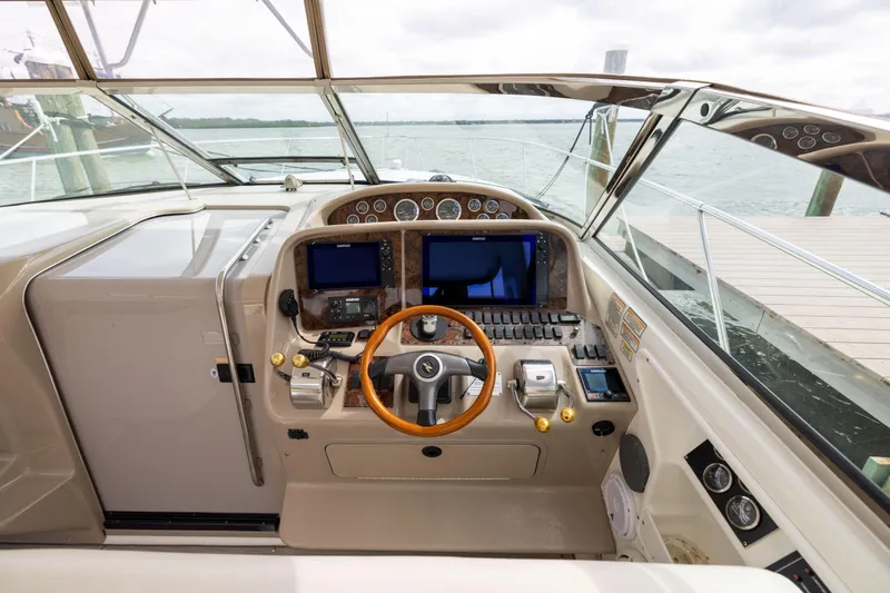 Slide: The Image of Cockpit of 2000 Sea Ray 370 Express Cruiser with steering wheel and navigation equipment. - 10