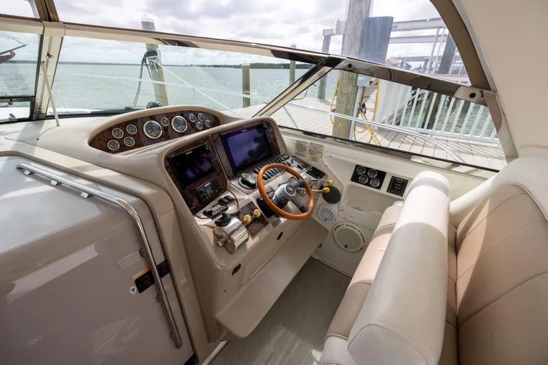 Slide: The Image of Cockpit of 2000 Sea Ray 370 Express Cruiser with steering wheel and navigation instruments. - 13