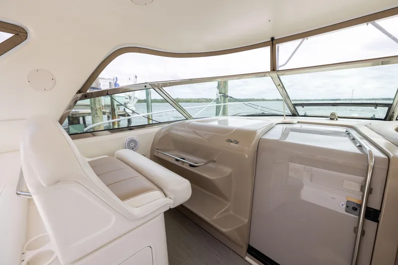 Slide: The Image of Interior view of 2000 Sea Ray 370 Express Cruiser helm with beige seating and dashboard. - 14