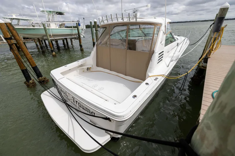 Slide: The Image of 2000 Sea Ray 370 Express Cruiser docked at marina, rear view. - 17