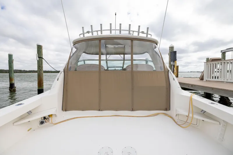 Slide: The Image of 2000 Sea Ray 370 Express Cruiser docked, rear view with covered cockpit area. - 18