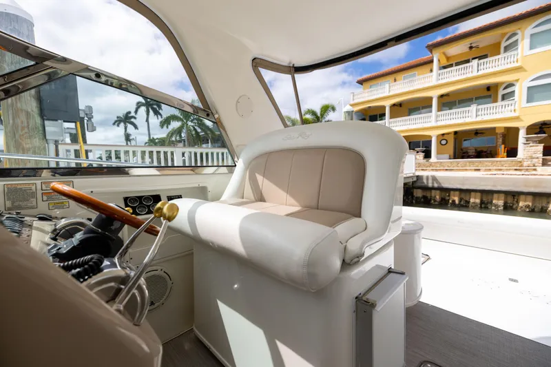Slide: The Image of Interior of 2000 Sea Ray 370 Express Cruiser with helm seat and waterfront view. - 20