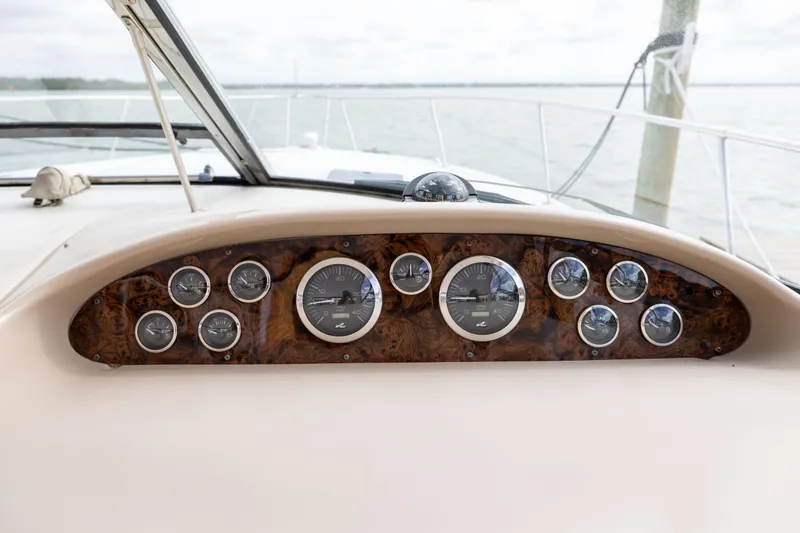 Slide: The Image of Dashboard of 2000 Sea Ray 370 Express Cruiser with gauges and wood finish. - 22