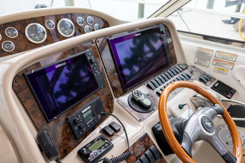 Slide: The Image of Helm of 2000 Sea Ray 370 Express Cruiser with Simrad navigation displays and wooden steering wheel. - 23
