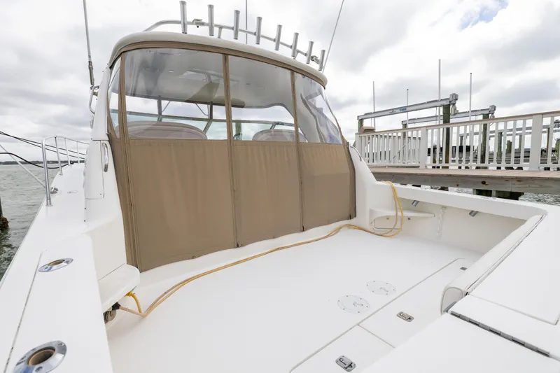 Slide: The Image of 2000 Sea Ray 370 Express Cruiser docked, featuring spacious deck and covered cockpit area. - 24