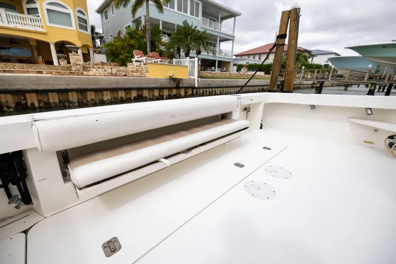 Slide: The Image of 2000 Sea Ray 370 Express Cruiser interior with seating, docked near waterfront homes. - 26