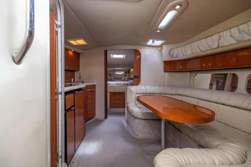 Slide: The Image of Interior of 2000 Sea Ray 370 Express Cruiser with kitchen and seating area. - 28