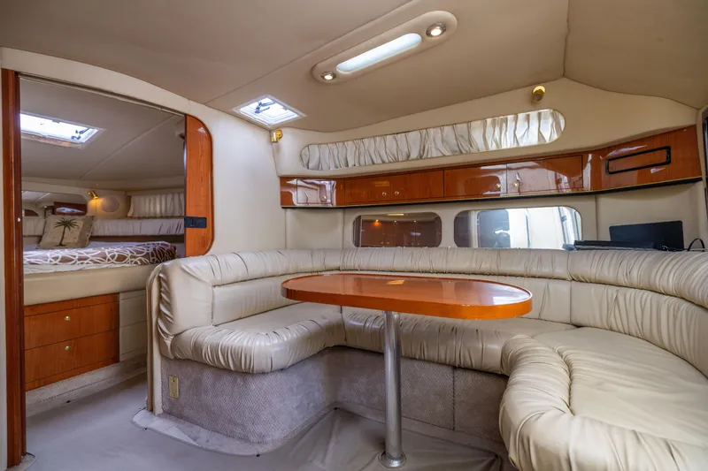 Slide: The Image of Luxurious interior of 2000 Sea Ray 370 Express Cruiser with plush seating and wooden accents. - 29