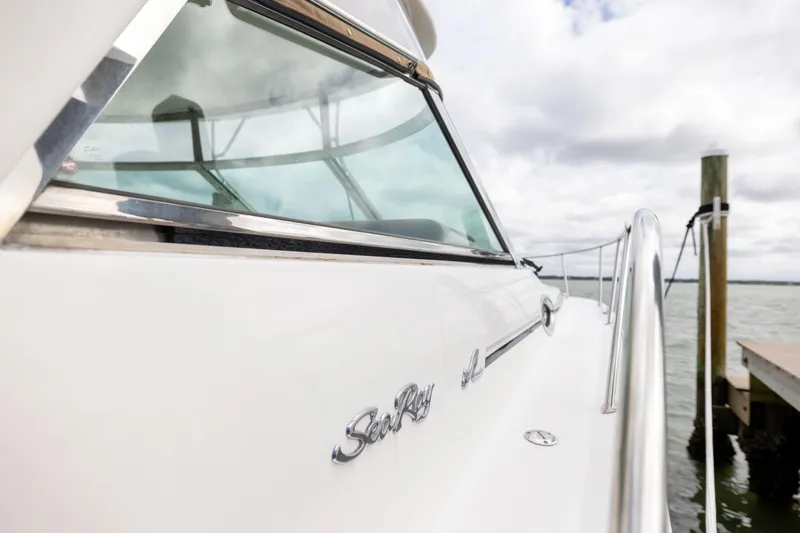 Slide: The Image of 2000 Sea Ray 370 Express Cruiser docked, showcasing sleek design and polished railing. - 33