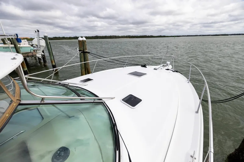 Slide: The Image of 2000 Sea Ray 370 Express Cruiser docked, showcasing sleek design and spacious deck. - 34