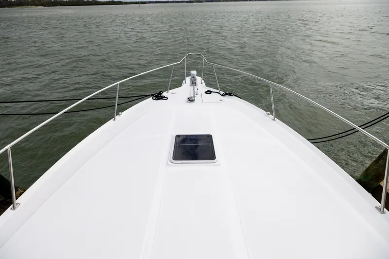 Slide: The Image of Bow view of 2000 Sea Ray 370 Express Cruiser on calm waters. - 35