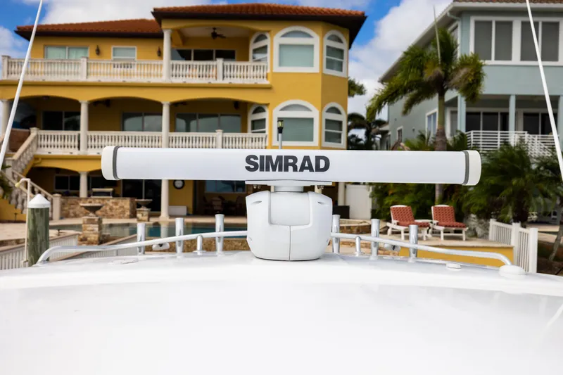 Slide: The Image of Radar on 2000 Sea Ray 370 Express Cruiser, with waterfront homes in the background. - 38