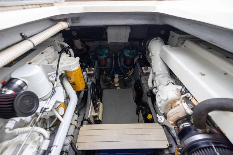 Slide: The Image of Engine room of a 2000 Sea Ray 370 Express Cruiser, showcasing mechanical components. - 42