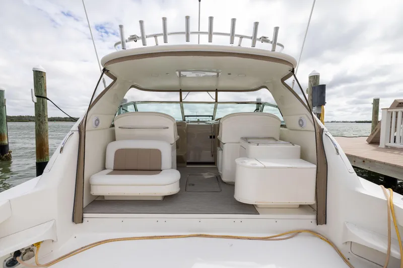 Slide: The Image of 2000 Sea Ray 370 Express Cruiser interior with seating, docked by the water. - 5