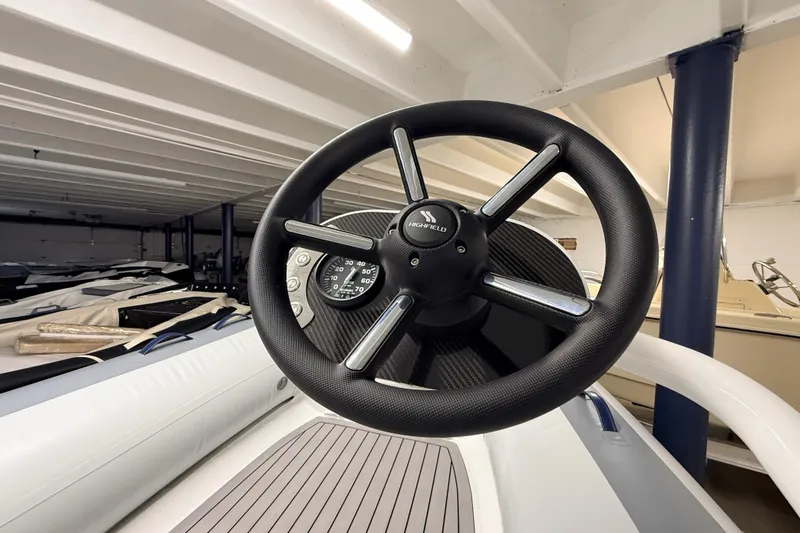 Slide: The Image of Steering wheel of 2025 Highfield Classic 400 boat in showroom setting. - 11