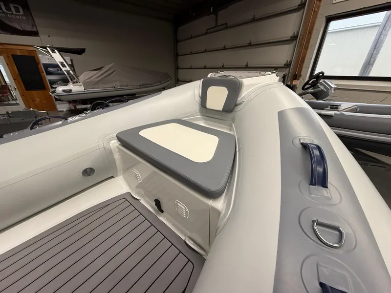 Slide: The Image of 2025 Highfield Classic 400 boat interior with cushioned seating and modern design. - 8
