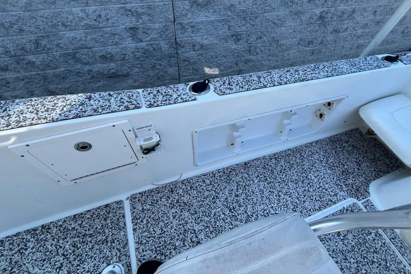 Slide: The Image of 2010 Sea Hunt Triton 220 boat interior with speckled flooring and seating. - 11