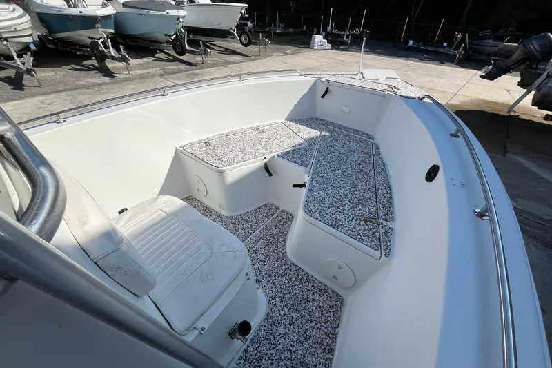 Slide: The Image of 2010 Sea Hunt Triton 220 boat interior with seating and storage compartments. - 13
