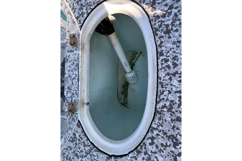 Slide: The Image of Livewell compartment of a 2010 Sea Hunt Triton 220 boat, featuring a speckled interior. - 17