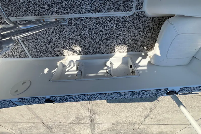 Slide: The Image of 2010 Sea Hunt Triton 220 boat interior with seating and storage compartment. - 18