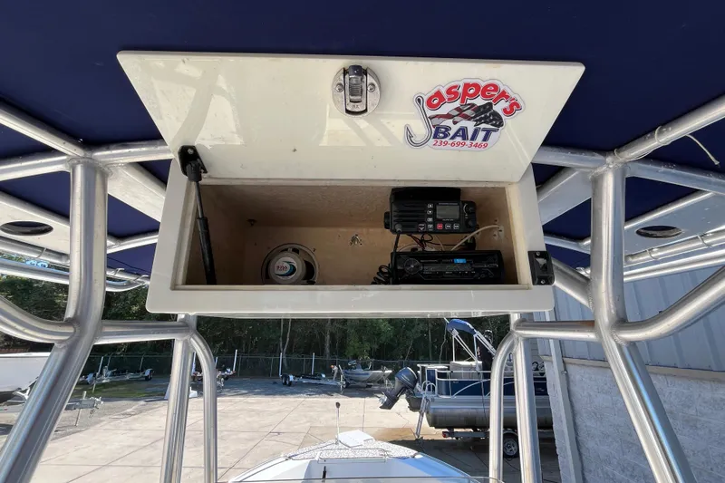 Slide: The Image of 2010 Sea Hunt Triton 220 boat console with electronics and storage compartment. - 21