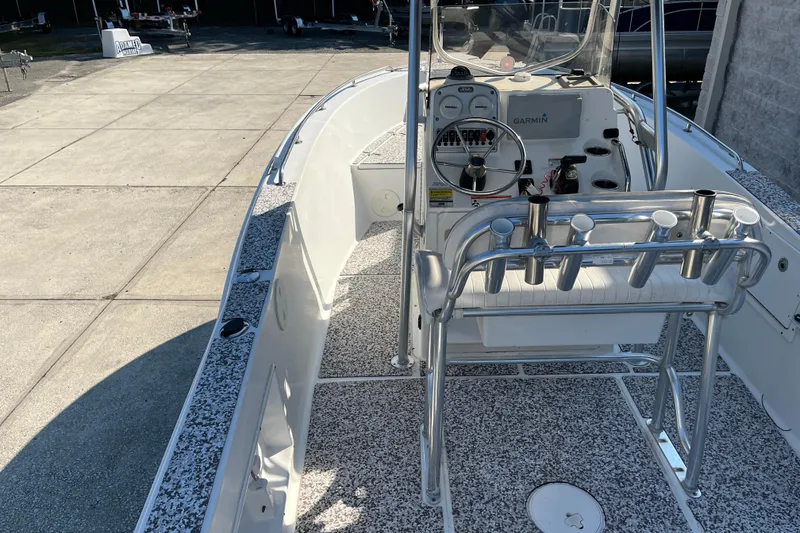 Slide: The Image of 2010 Sea Hunt Triton 220 boat interior with steering console and rod holders. - 3