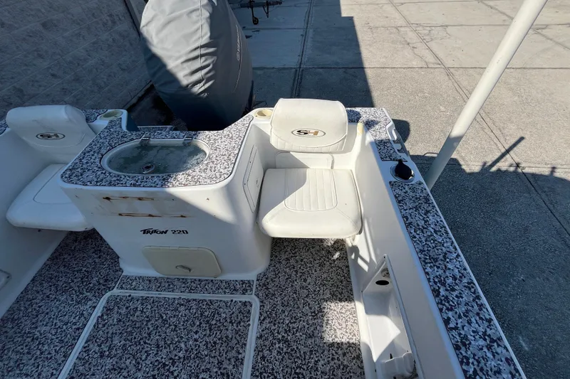 Slide: The Image of 2010 Sea Hunt Triton 220 boat interior with seating and livewell. - 7