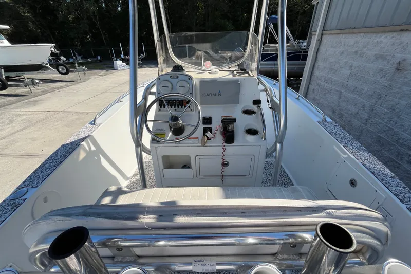 Slide: The Image of 2010 Sea Hunt Triton 220 boat cockpit with steering wheel and Garmin navigation system. - 8