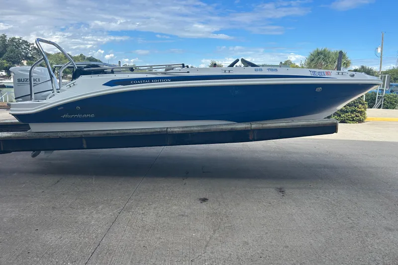 The Image of 2022 Hurricane SunDeck Sport 185 OB boat on trailer, Coastal Edition, blue and white design. - 0