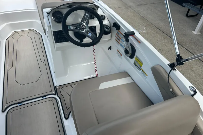 Slide: The Image of 2022 Hurricane SunDeck Sport 185 OB boat cockpit with steering wheel and seating. - 15