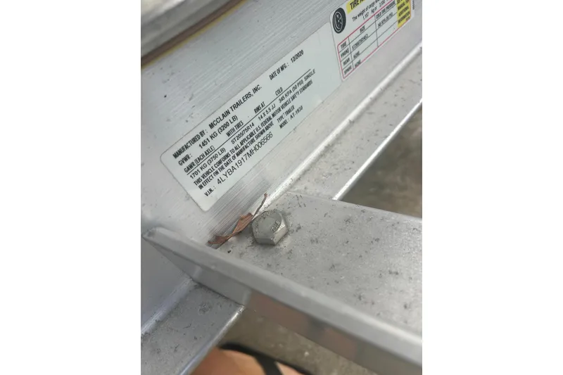 Slide: The Image of Close-up of a 2022 Hurricane SunDeck Sport 185 OB trailer label and bolt. - 25