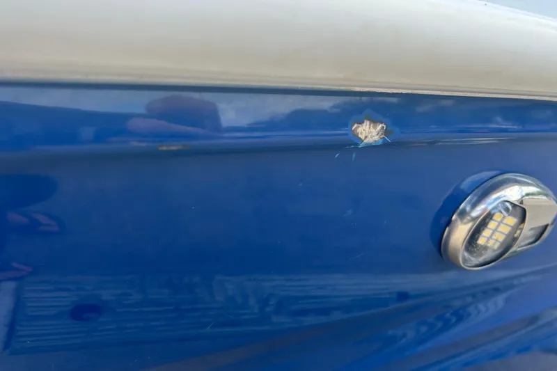 Slide: The Image of Close-up of 2022 Hurricane SunDeck Sport 185 OB with hull damage and LED light. - 28