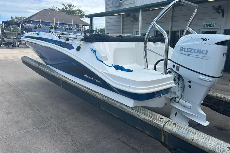 Slide: The Image of 2022 Hurricane SunDeck Sport 185 OB boat with Suzuki outboard motor on a trailer. - 3