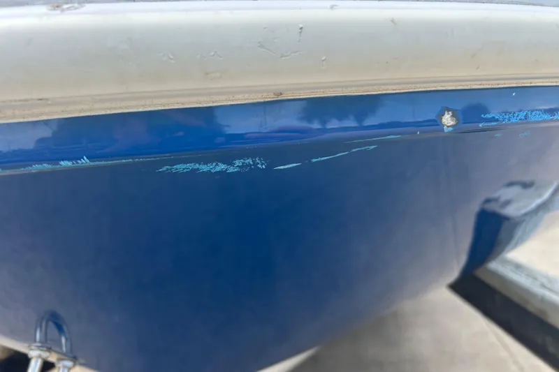 Slide: The Image of 2022 Hurricane SunDeck Sport 185 OB boat with visible hull scratches and damage. - 30