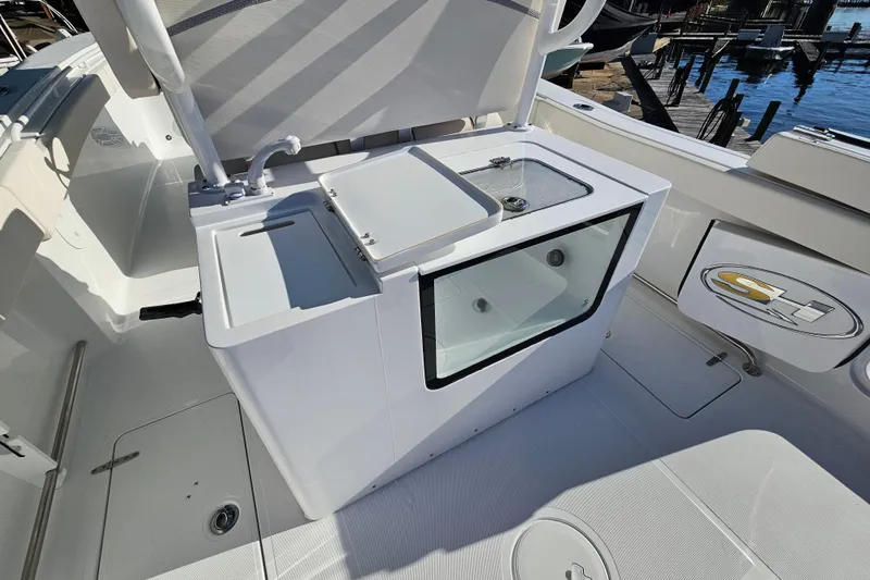 Slide: The Image of 2026 Sea Hunt Gamefish 30 Forward Seating boat interior with livewell and storage features. - 15