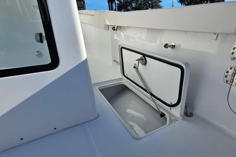 Slide: The Image of 2026 Sea Hunt Gamefish 30 Forward Seating boat interior with open storage compartment. - 20