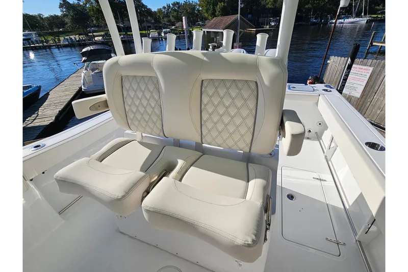 Slide: The Image of Luxury seating on 2026 Sea Hunt Gamefish 30 boat, docked by a scenic waterfront. - 30
