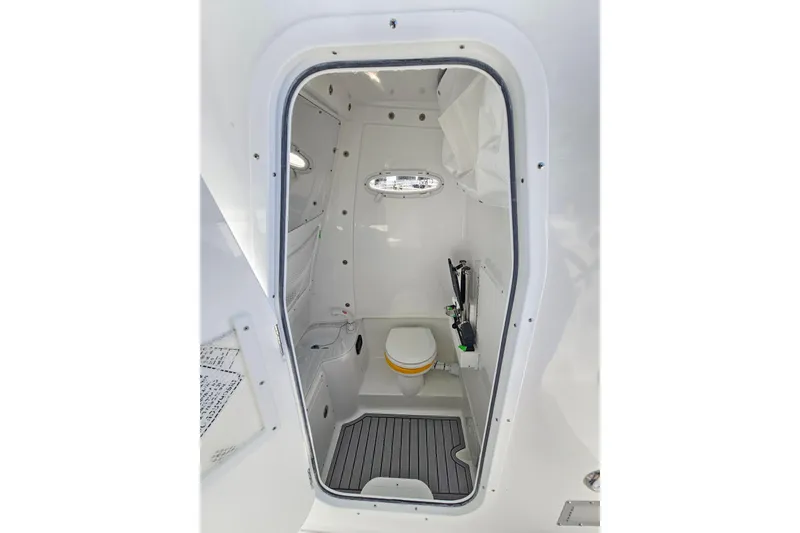Slide: The Image of 2026 Sea Hunt Gamefish 30 Forward Seating boat interior with compact bathroom. - 38