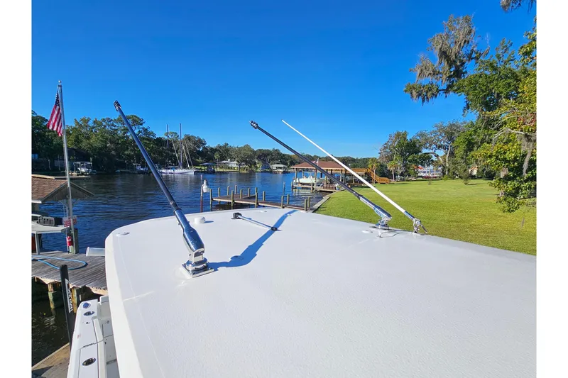 Slide: The Image of 2026 Sea Hunt Gamefish 30 boat docked by a scenic waterfront with clear blue skies. - 42