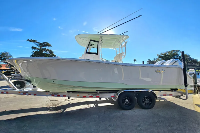 Slide: The Image of 2026 Sea Hunt Gamefish 30 Forward Seating boat on trailer, sunny day. - 5