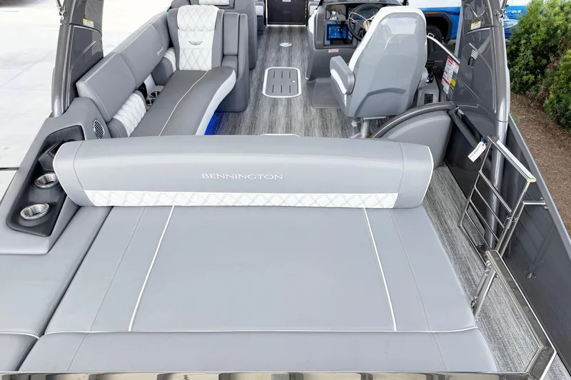 Slide: The Image of 2025 Bennington 23RX boat interior with luxurious gray seating and modern design. - 10