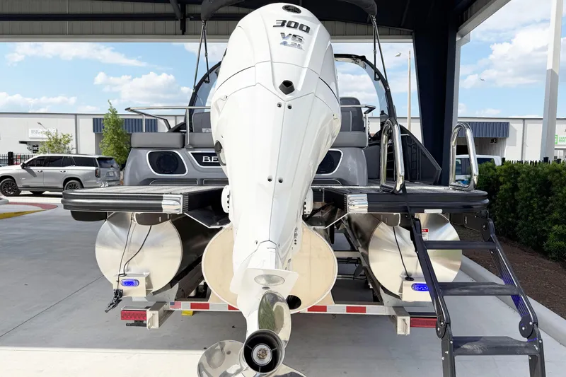 Slide: The Image of 2025 Bennington 23RX pontoon boat with powerful 300 HP engine, docked outdoors. - 5