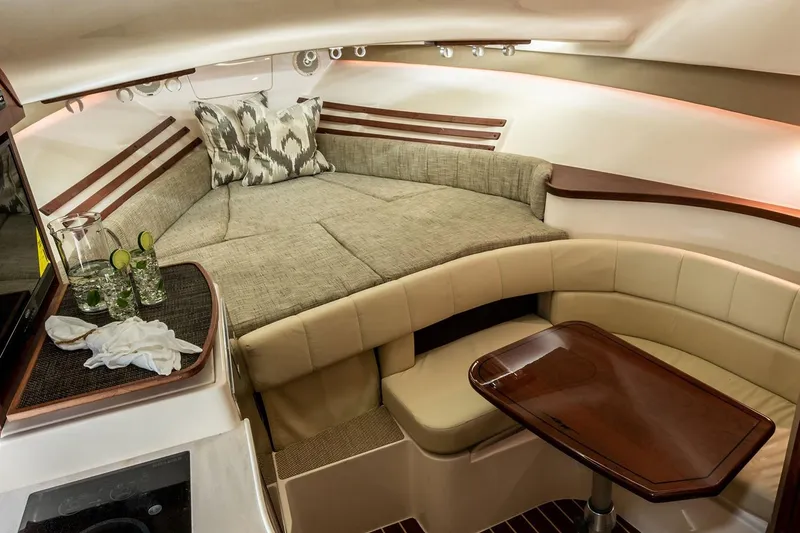 Slide: The Image of 2019 Grady-White Express 330 boat interior with teak flooring and seating area. - 19